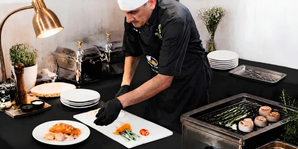 Chef Javier plating a meal at an event service table