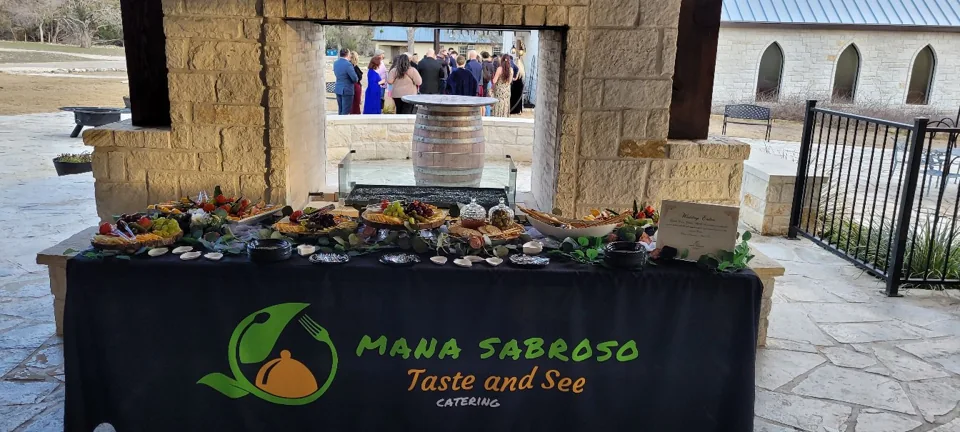 Mana Sabroso appetizer table set beneath a stone pavilion