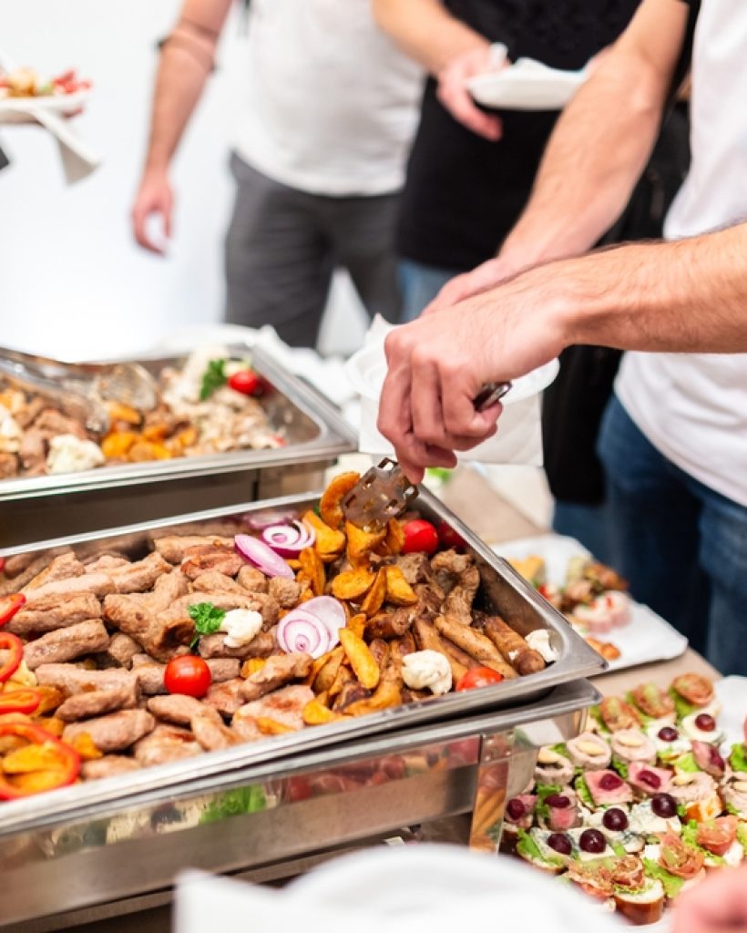 Man,Scooping,Seafood,From,Warming,Tray.,Meal,Buffet,Lunch.
