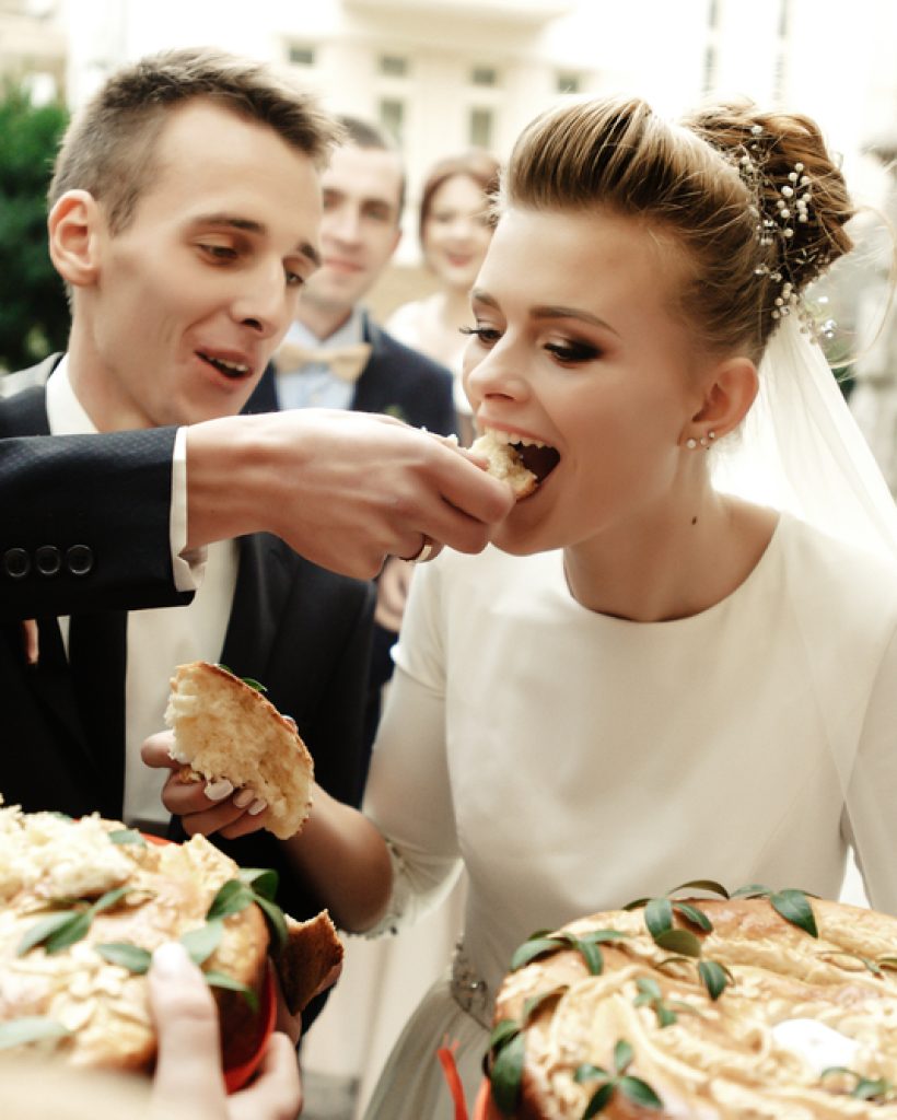 Happy,Bride,And,Groom,Tasting,Cake,And,Laughing,,Funny,Moment,